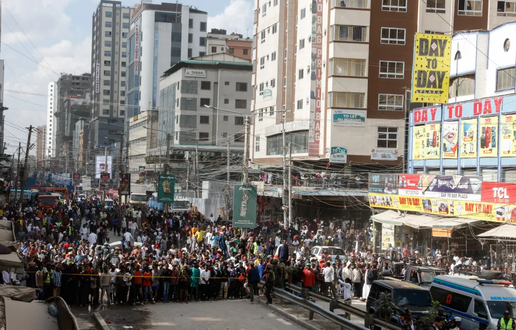 People gather at the site of a building collapse in Nairobi, Kenya.