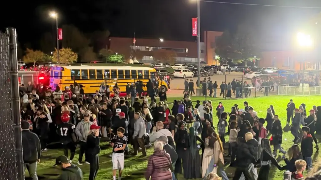 People leave Eden Prairie High School after a football game was evacuated.