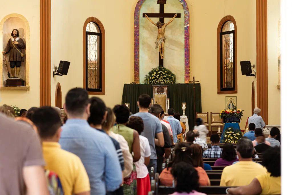 People line up for communion during a Catholic Mass.