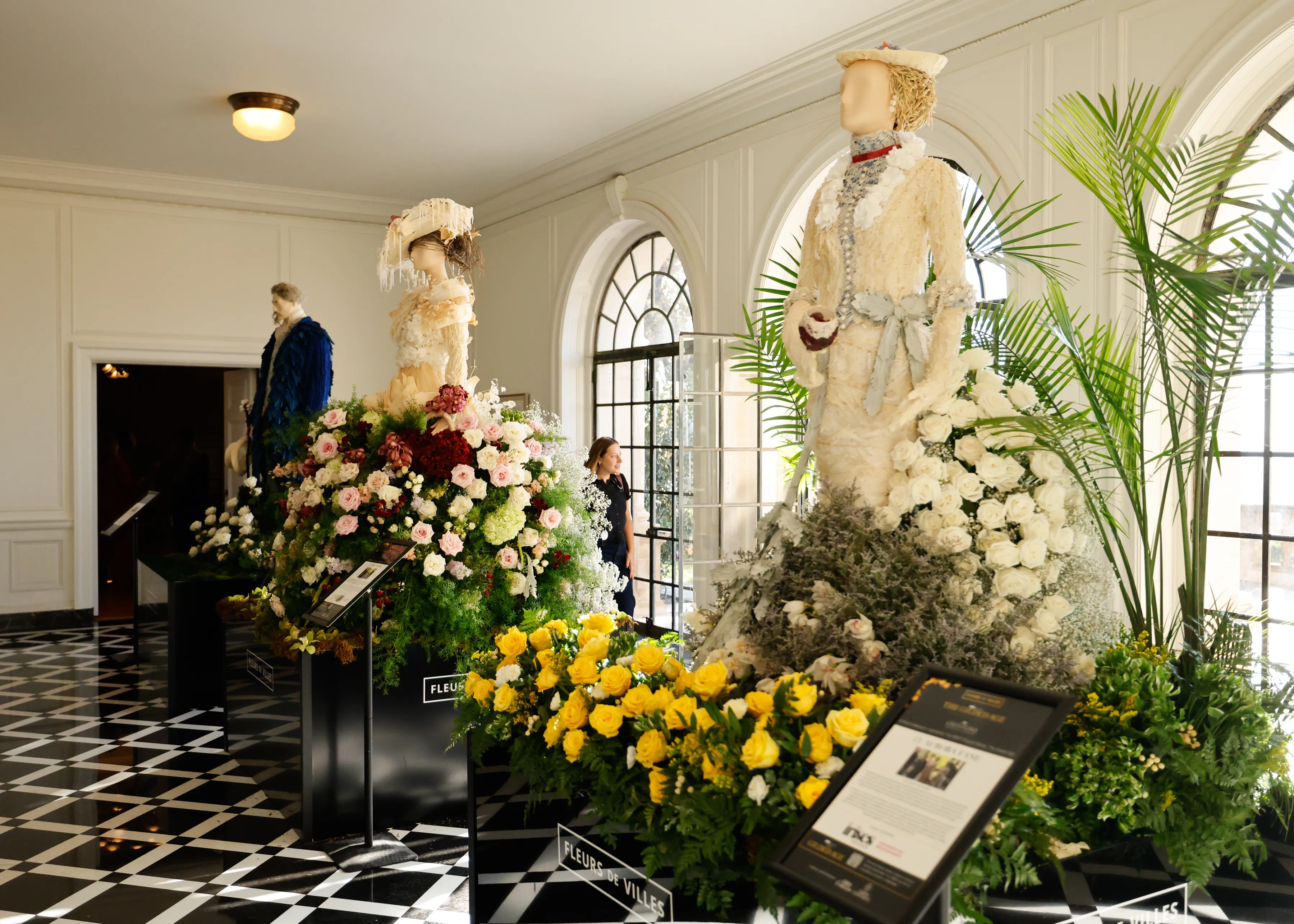 People look at flower sculptures at the 