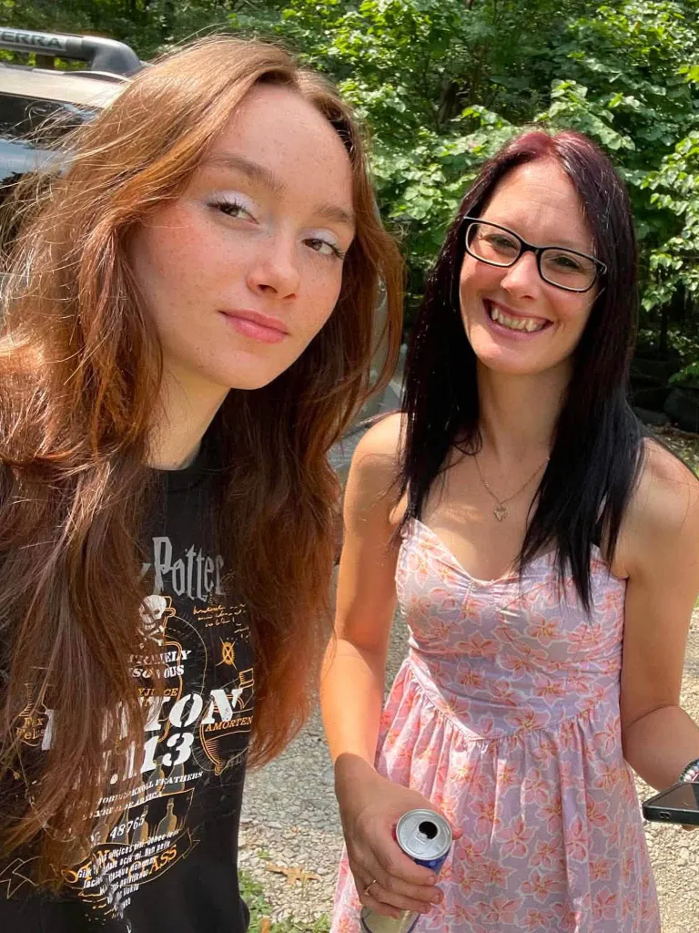Persephone and her mother, Joy-Jarrad Berger, posing for a photo outdoors.