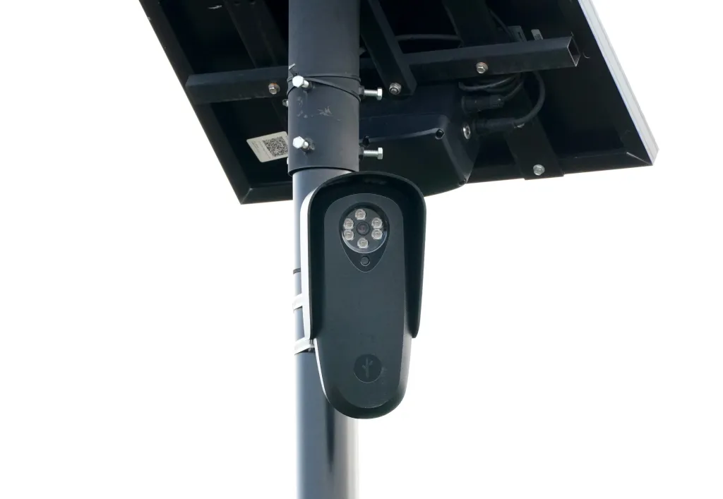 A Flock Safety surveillance camera mounted on a pole with a solar panel.