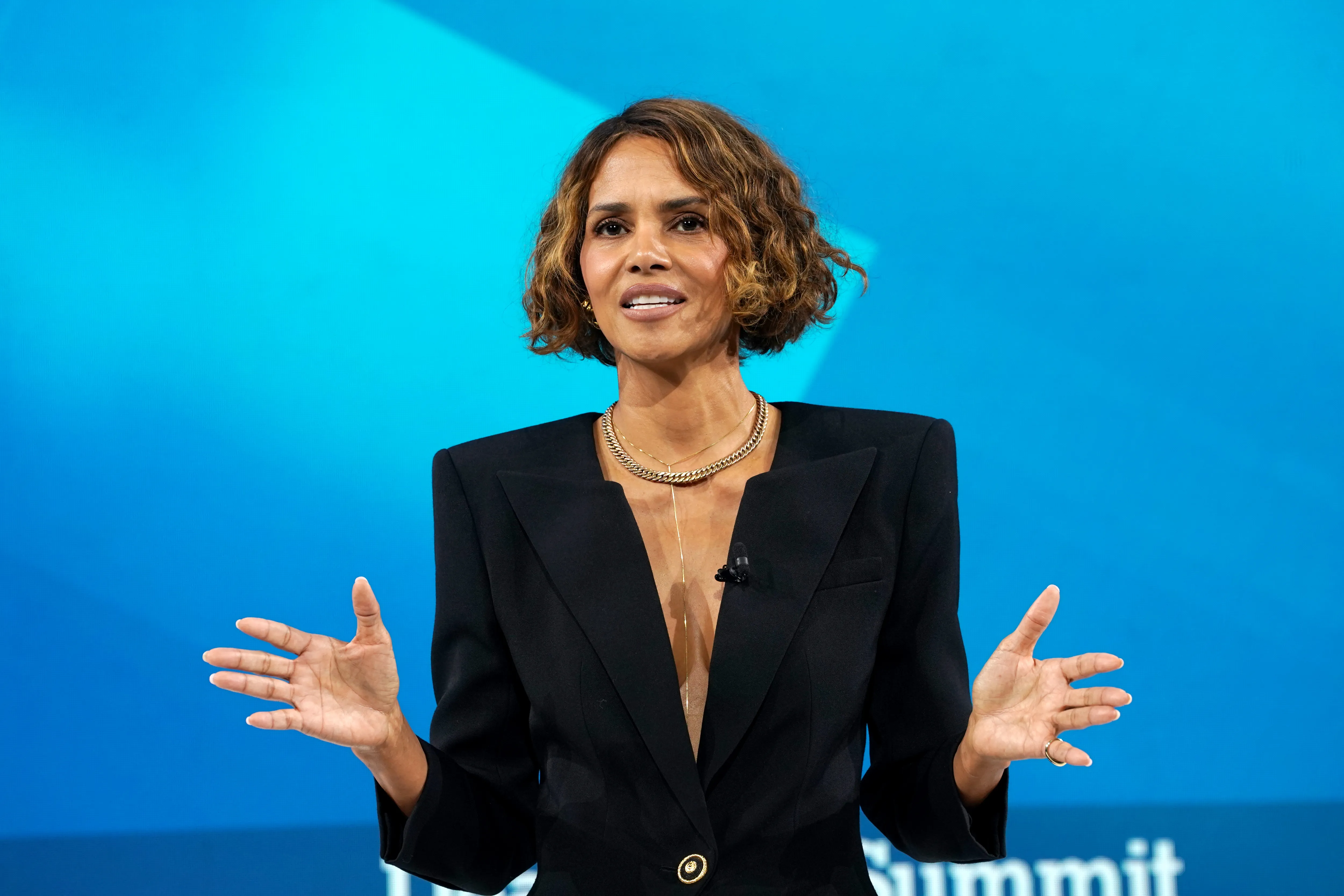 Halle Berry speaks onstage at a summit.
