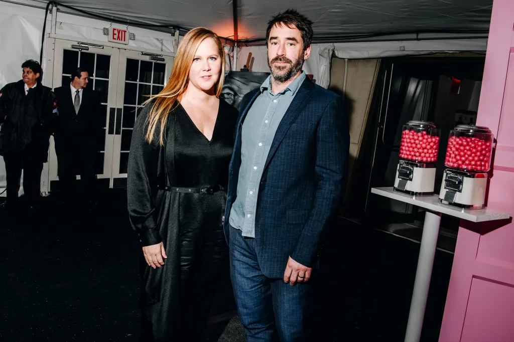 Amy Schumer and Chris Fischer at the Charlize Theron's Africa Outreach Project Fundraising Event.
