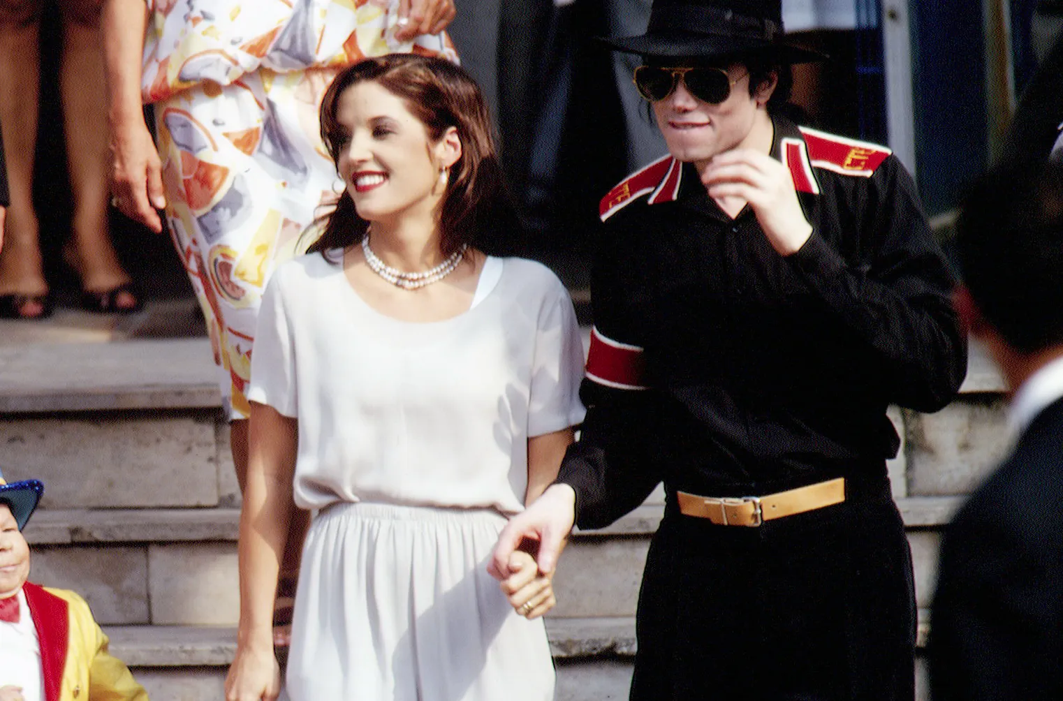 Michael Jackson and Lisa Marie Presley holding hands and smiling in Budapest.