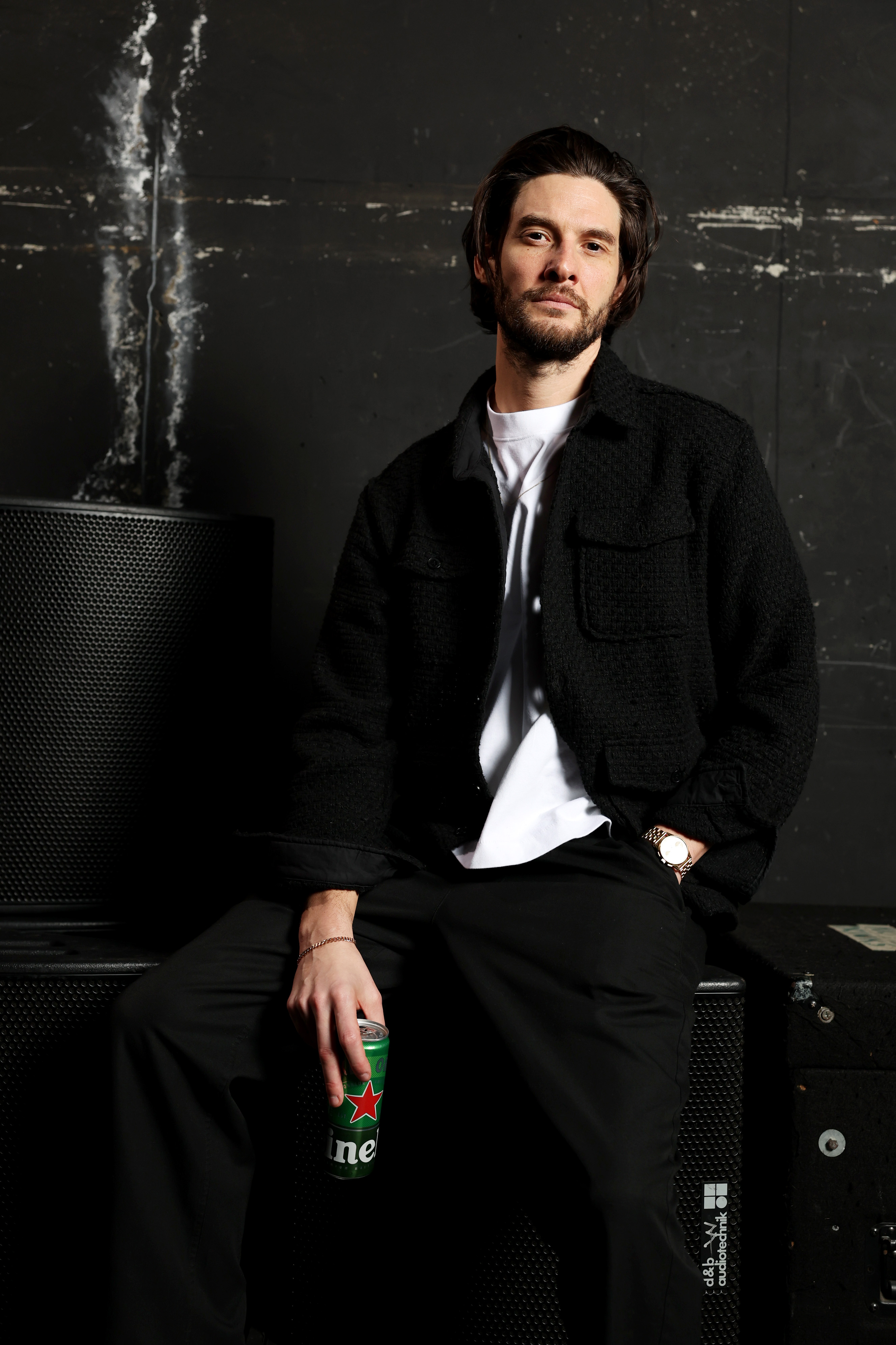 Ben Barnes poses backstage, holding a beverage.