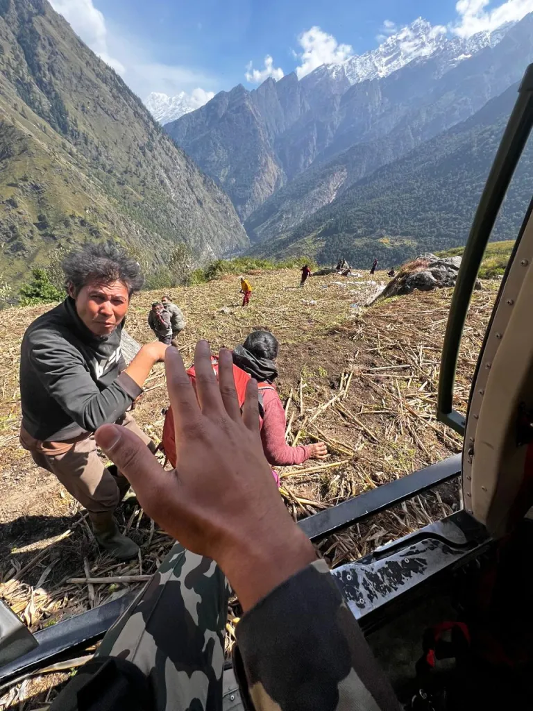 Residents affected by flooding in north central Nepal are evacuated by a helicopter.