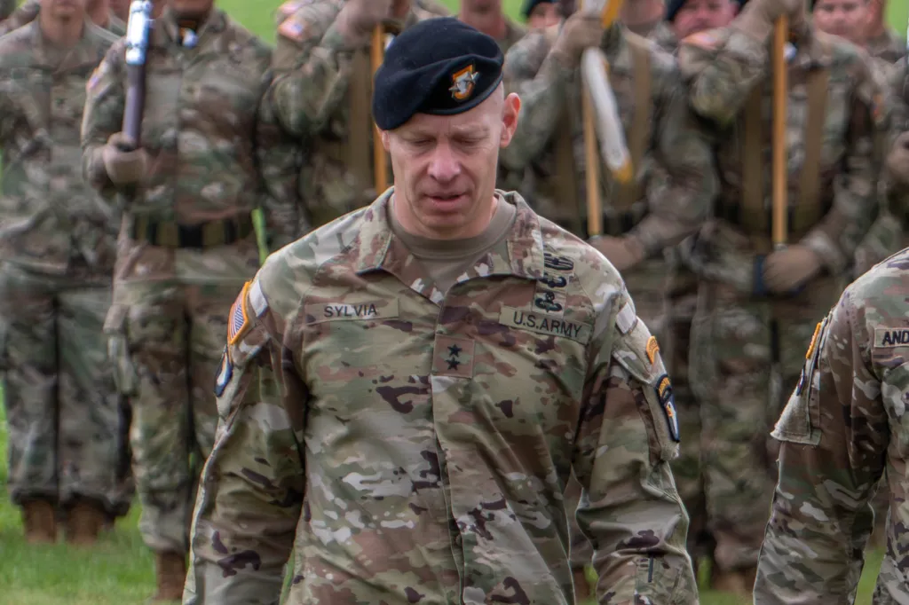 Maj. Gen. Brett Sylvia in uniform with other soldiers in the background.
