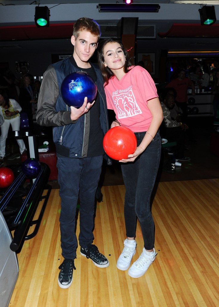 Presley Gerber and Kaia Gerber pose with bowling balls at the 2015 Bowling for Buddies event.