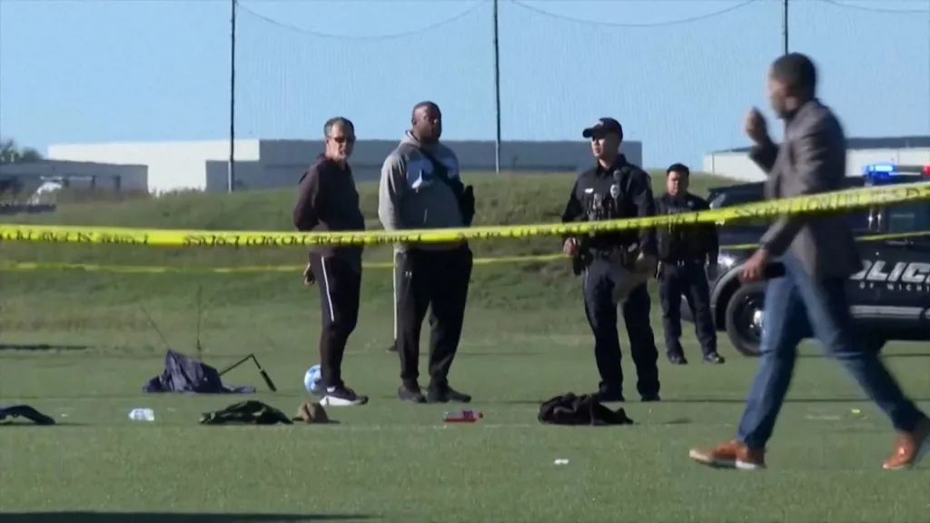 Police officers stand behind yellow crime scene tape at the Stryker Sports Complex in Wichita, Kansas.