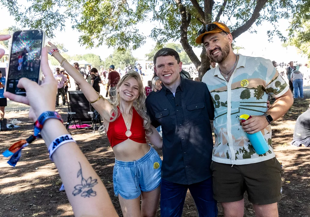 Politician James Talarico, center, poses for a photo with fans at the Austin City Limits Music Festival.