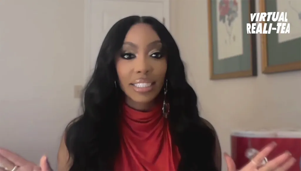 Porsha Williams in a video interview wearing a red top.