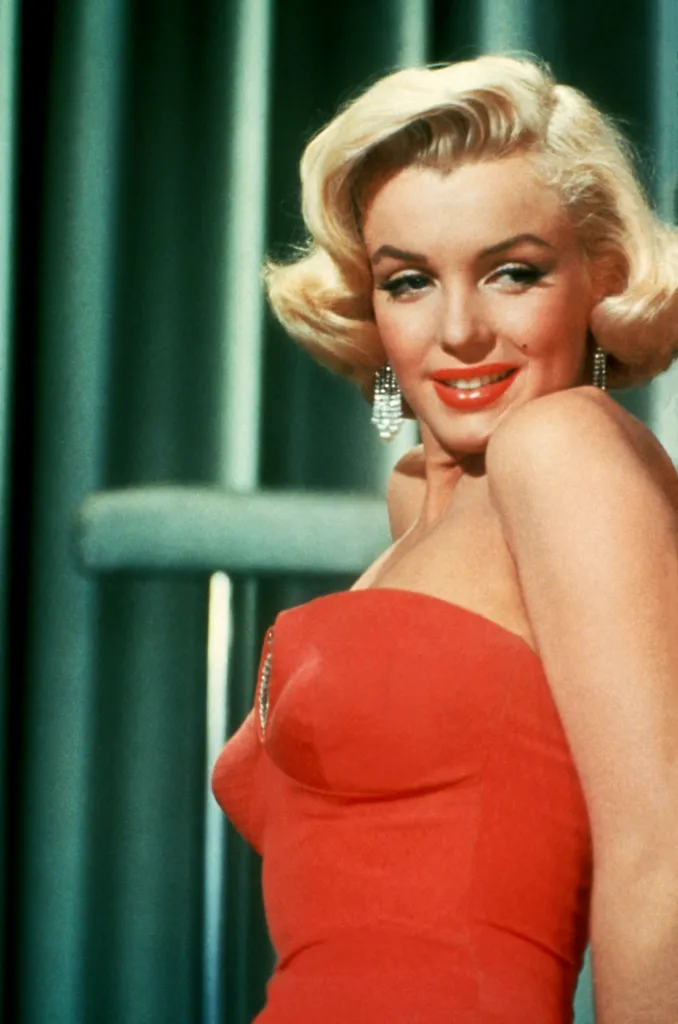 Portrait of Marilyn Monroe wearing a red dress.