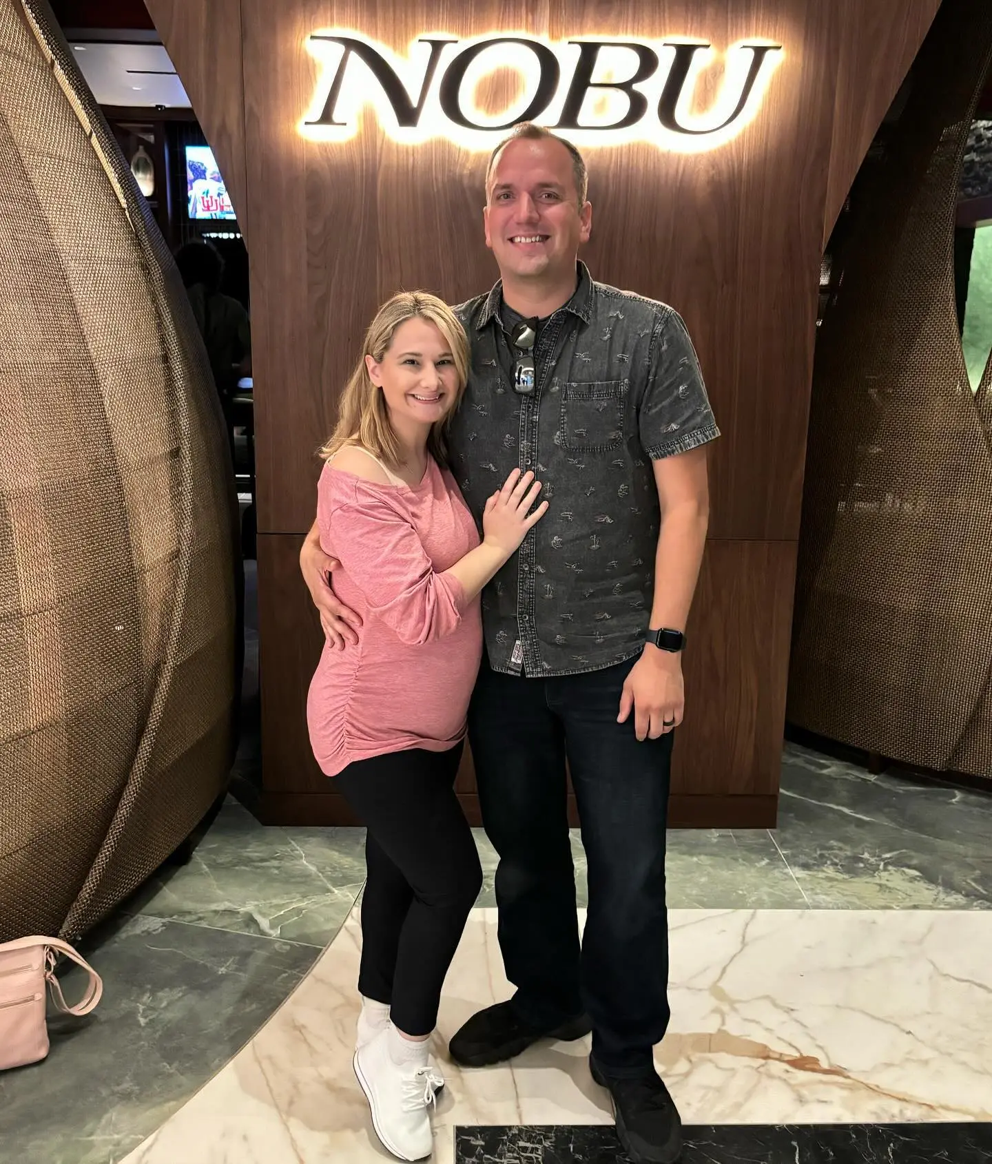 Gypsy-Rose Blanchard and Ken Urker pose together in front of a Nobu sign.