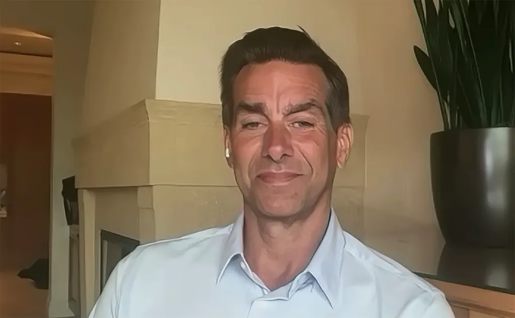 Jason Galanis wearing a light blue button-down shirt.