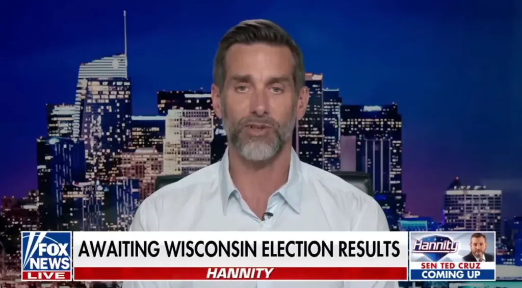 Jason Galanis on Fox News with a city skyline in the background.