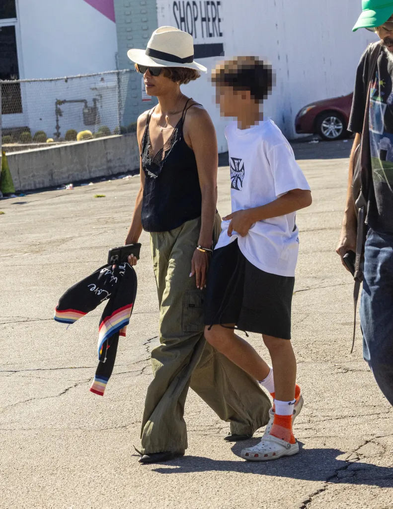 Halle Berry walking outdoors with her son Maceo and partner Van Hunt.