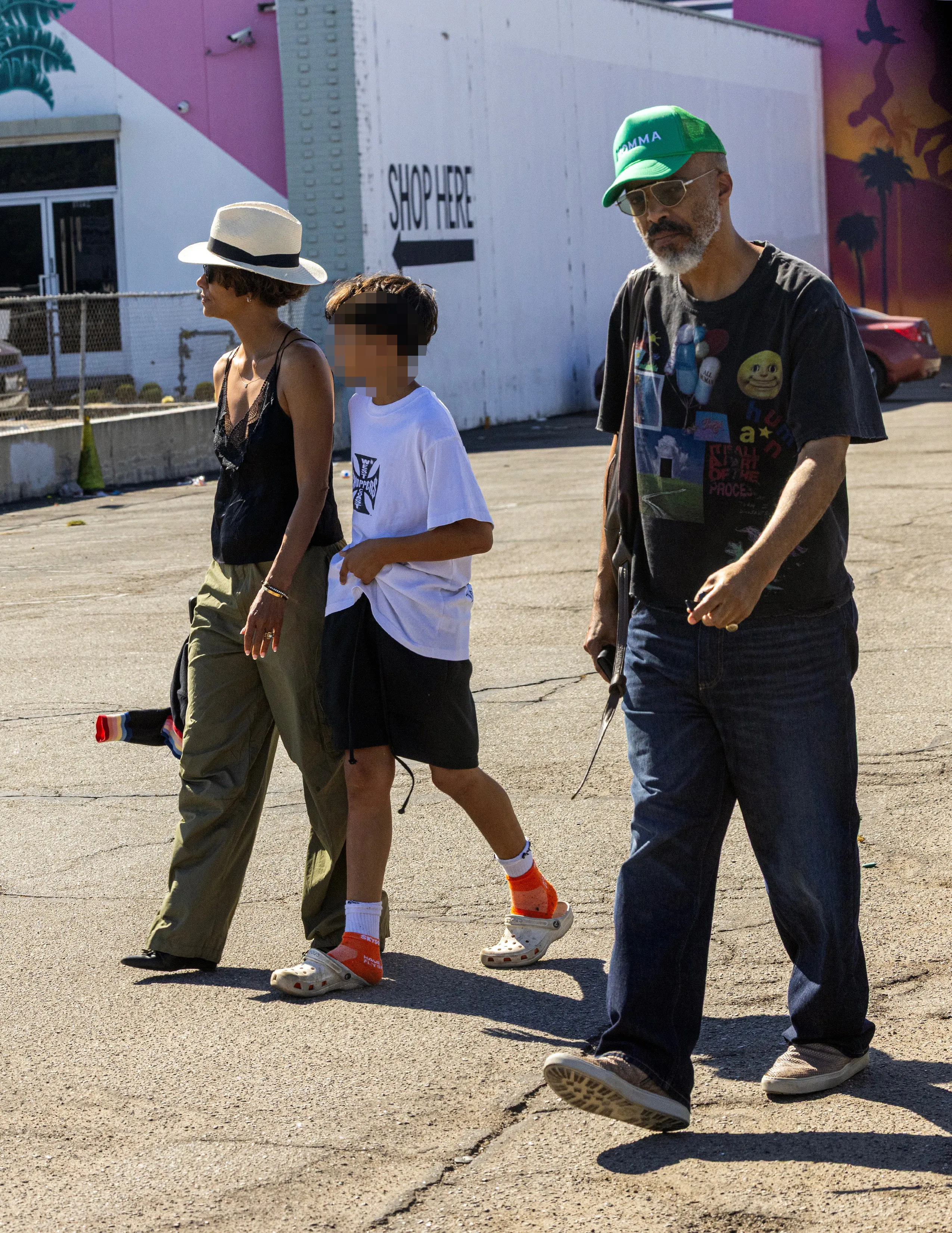 Halle Berry walks outside in Los Angeles with her partner Van Hunt and son Maceo.