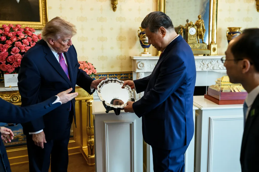 President Donald J. Trump and President Xi Jinping of China exchange a gift in the White House.