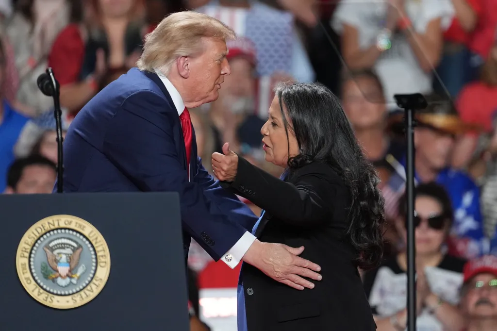 President Donald Trump greets Marie Herrera Vega at a campaign rally at the Freeman Coliseum in San Antonio.