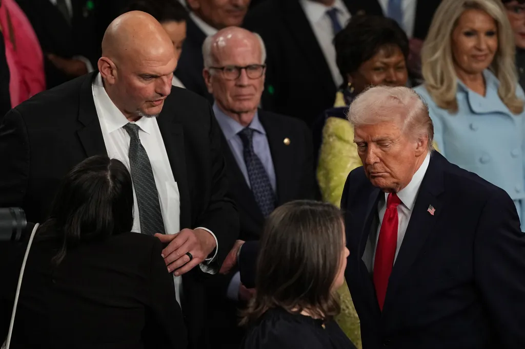 President Donald Trump passes Sen. John Fetterman, D-Pa., as he departs after delivering the State of the Union address to a joint session of Congress in the House chamber at the US Capitol in Washington, DC on Feb. 24, 2026.