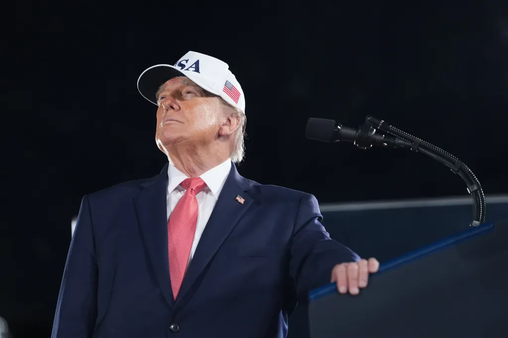 President Donald Trump watches a video at a campaign rally.