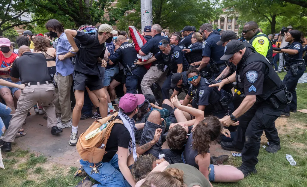 Pro-Palestinian demonstrators clash with police after replacing an American flag with a Palestinian flag on April 30, 2024, at UNC-Chapel Hill.