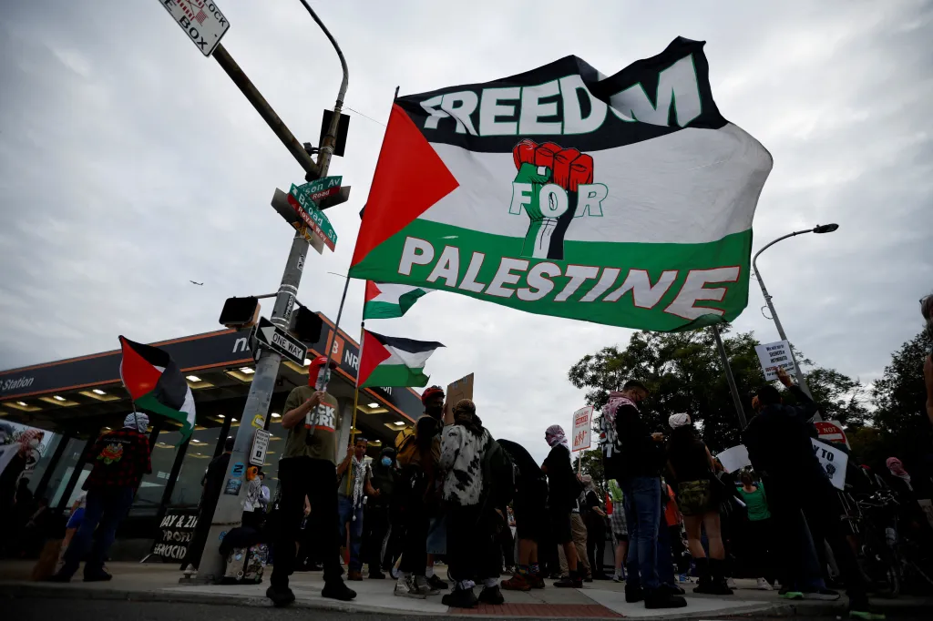 Pro-Palestinian demonstrators holding flags and signs outside Ed Sheeran's concert venue in Philadelphia.