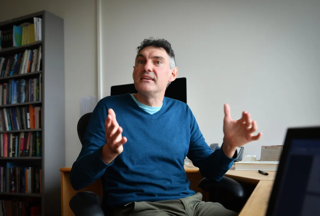 Professor of Economics Emmanuel Saez gestures while speaking in his office at the University of California Berkeley.