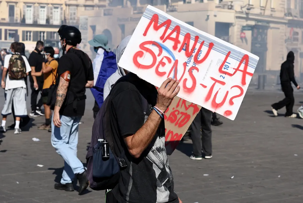 A protester holds a sign reading 
