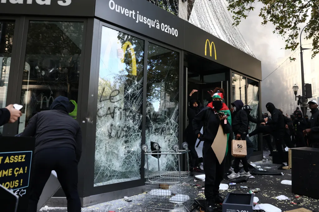 Protesters vandalize a McDonald's restaurant amid clashes during a day of demonstrations against the cost of living and rising fuel prices in Paris as part of nationwide protests called by the 