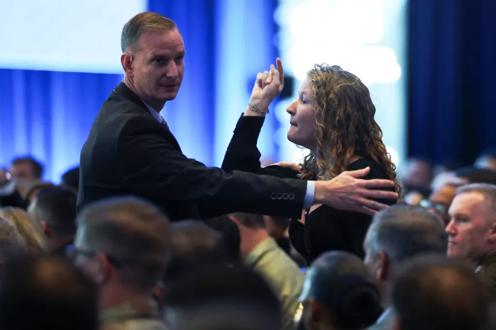 A protestor is removed after interrupting a discussion with U.S. Secretary of War Pete Hegseth during the U.S. Army's Annual Meeting and Exposition.