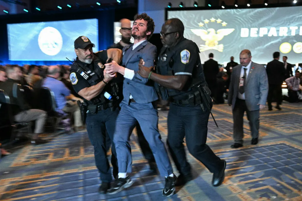 Security personnel remove a protestor as U.S. Secretary of Defense Pete Hegseth speaks at the Association of the United States Army (AUSA) Annual Meeting and Exposition in Washington.