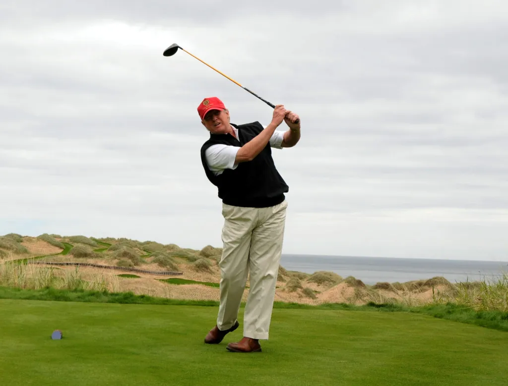 Donald Trump swings a golf club on his Menie Estate golf course in Aberdeenshire, Scotland.