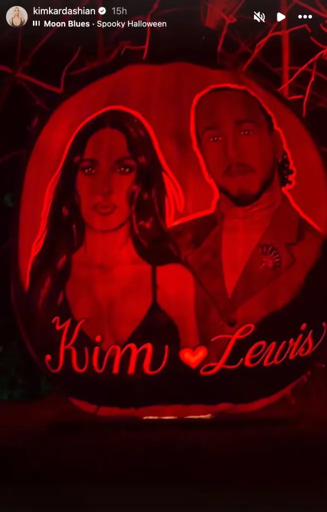Pumpkin carving of Kim Kardashian and Lewis Hamilton with their names and a heart carved below them, illuminated by a red light.