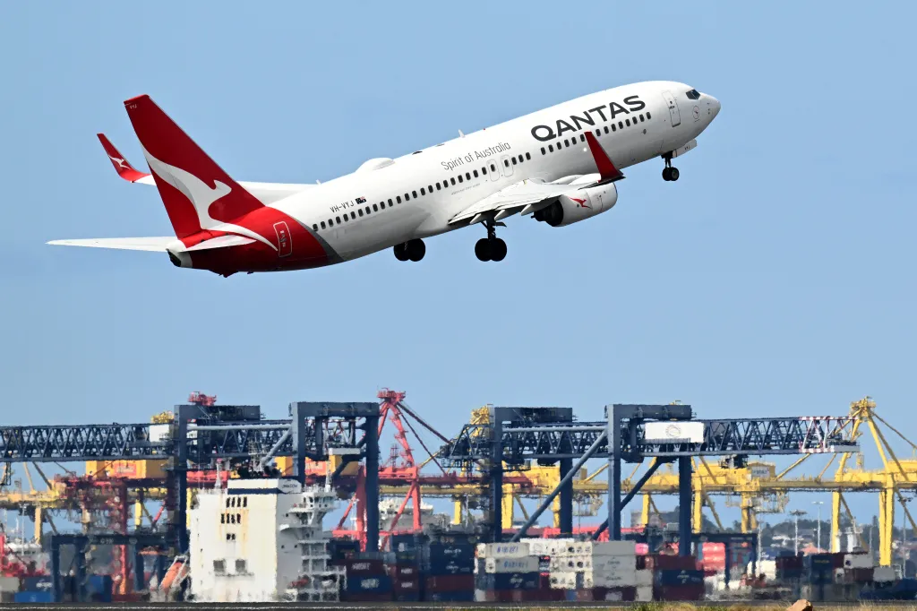 A Qantas airline flight takes off from Sydney International Airport.