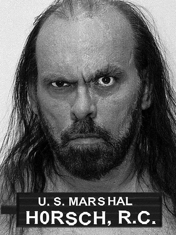 Black and white photo of R.C. Horsch with a U.S. Marshal placard.