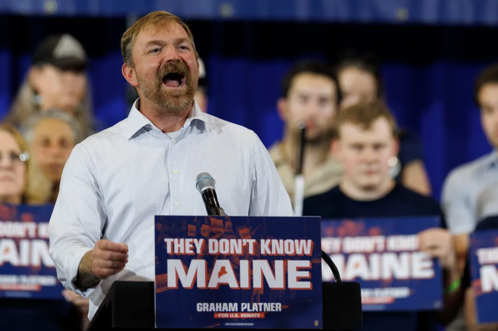 Democratic U.S. Senate candidate Graham Platner speaks passionately at his Primary Election event in Blue Hill, Maine, with campaign signs reading 