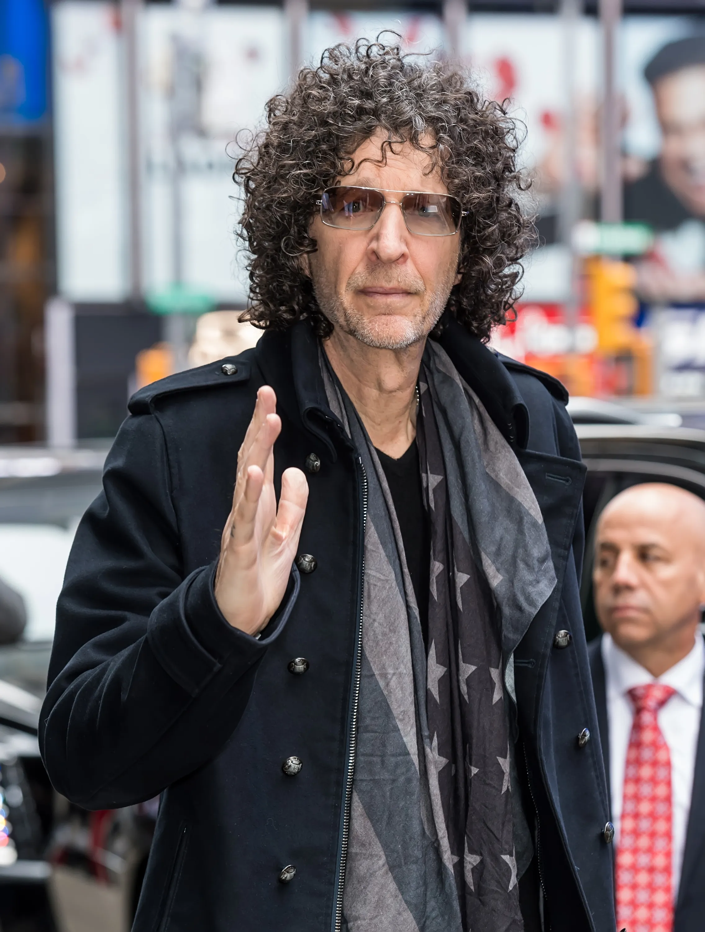 Radio and television personality Howard Stern waving while arriving at a studio.