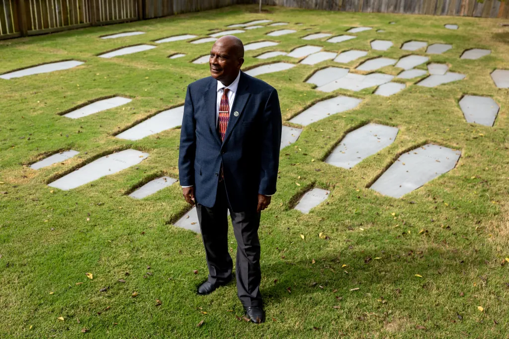 Reginald F. Davis, pastor of First Baptist Church, standing in the burial ground outside the church in Williamsburg, Va.