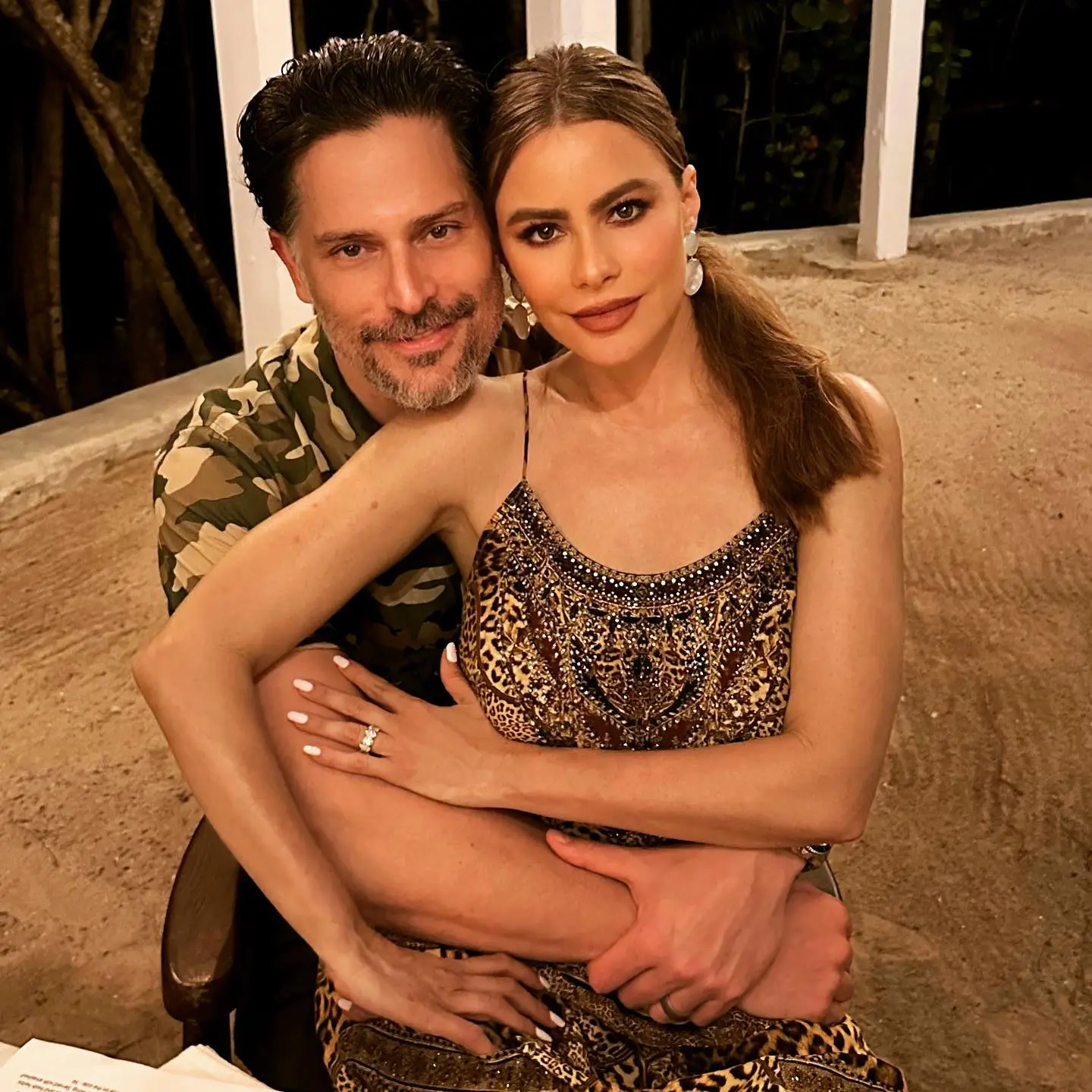 Sofia Vergara and Joe Manganiello posing together, with Manganiello embracing Vergara from behind.