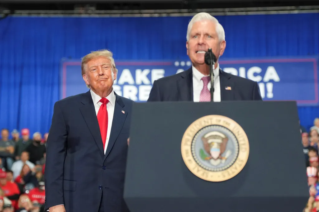 Republican candidate for New York governor Bruce Blakeman speaks as U.S. President Donald Trump looks on during a campaign rally.