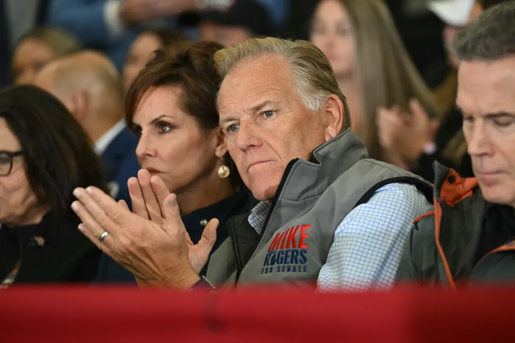 Republican candidate for U.S. Senate Mike Rogers listens at a campaign rally.
