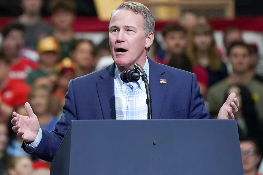 Republican Sen. Jon Husted speaks at a podium during a rally at Butler High School.