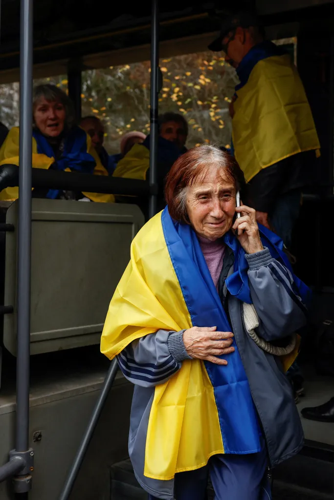An elderly resident evacuated from the Russian-occupied town of Oleshky speaks on a mobile phone after returning to Ukrainian-controlled territory.