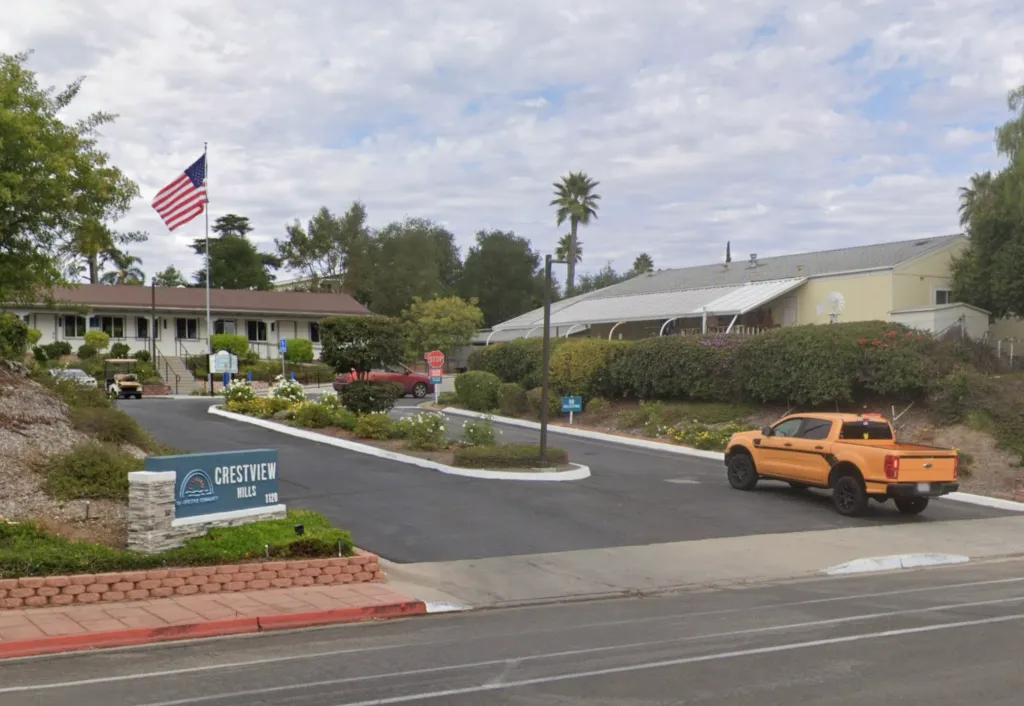 Entrance to the Crestview Hills Mobile Home Park in Fallbrook, California, with an orange truck parked nearby.