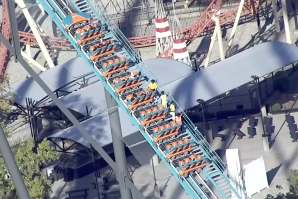 Aerial view of riders being escorted down a roller coaster track.