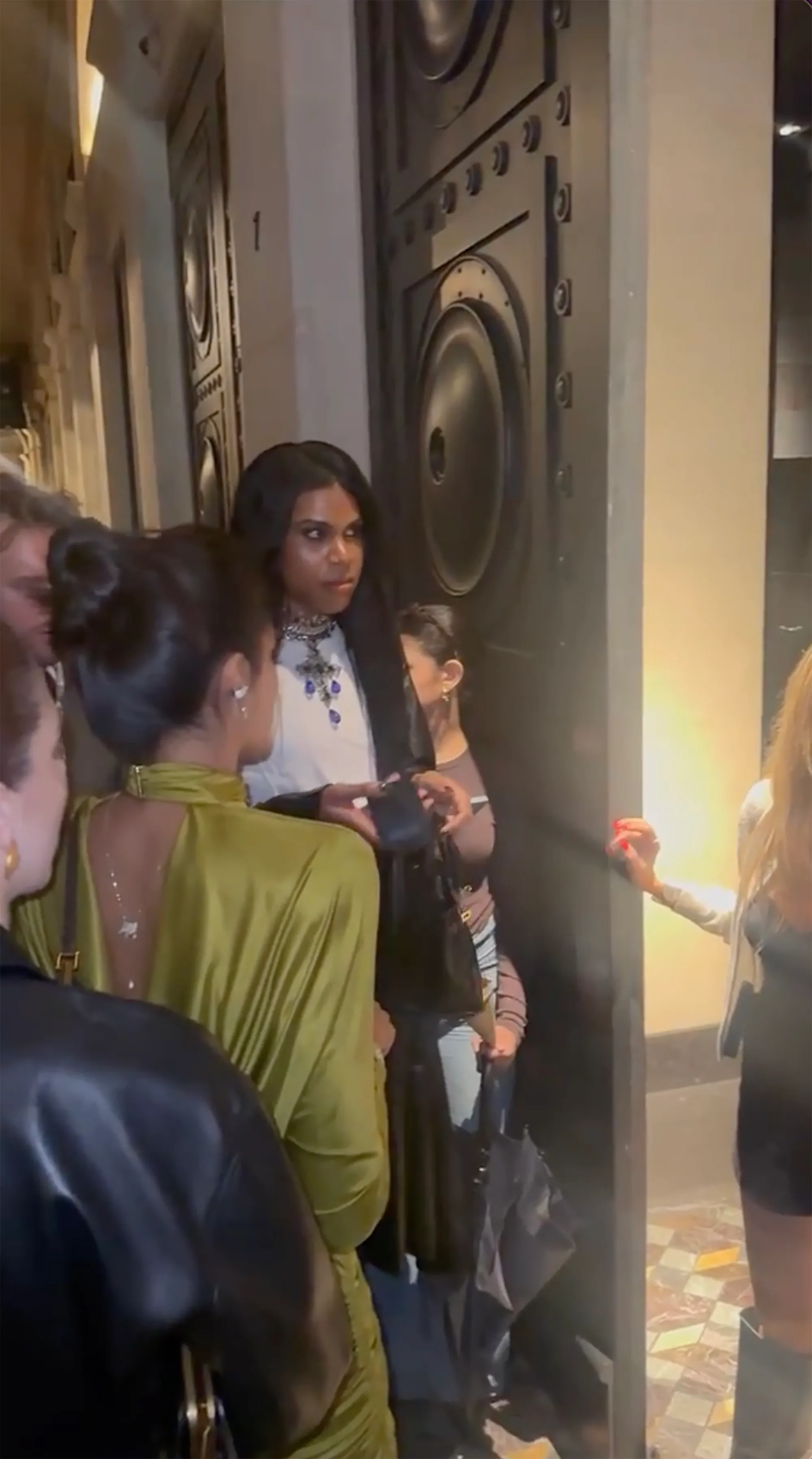 EJ Johnson standing in a doorway surrounded by people.