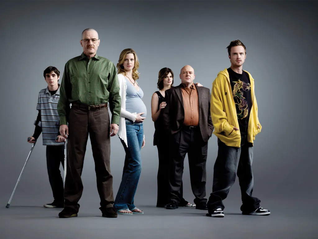 Cast photo of Breaking Bad featuring RJ Mitte, Bryan Cranston, Anna Gunn, Betsy Brandt, Dean Norris, and Aaron Paul.