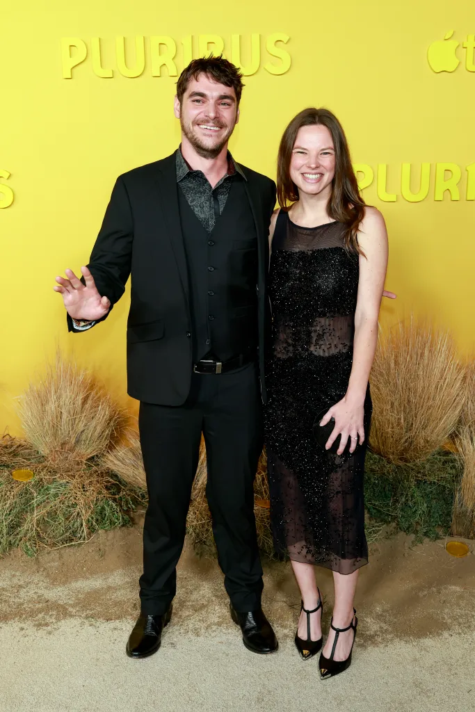RJ Mitte and Kennedy Suarez posing on the yellow carpet at the world premiere of 